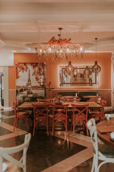 A luxurious dining room featuring rustic decor, a large table, and Eiffel Tower artwork, creating a warm and inviting atmosphere.