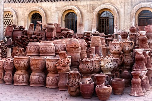 Free A diverse collection of traditional handmade pottery displayed outdoors, showcasing various styles and craftsmanship. Stock Photo