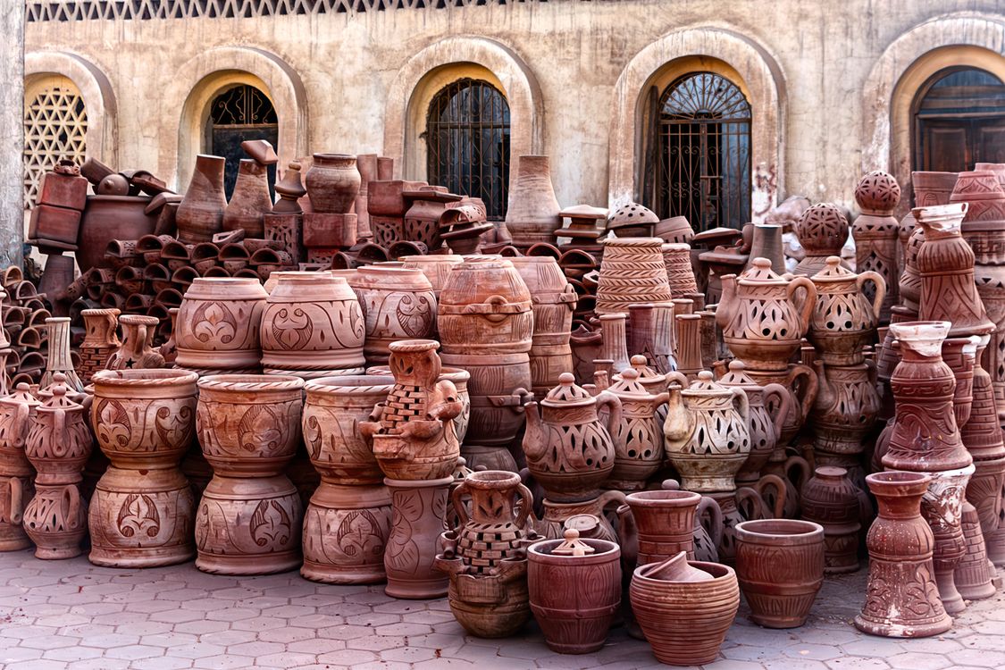 A large group of clay pots sitting on a sidewalk · Free Stock Photo