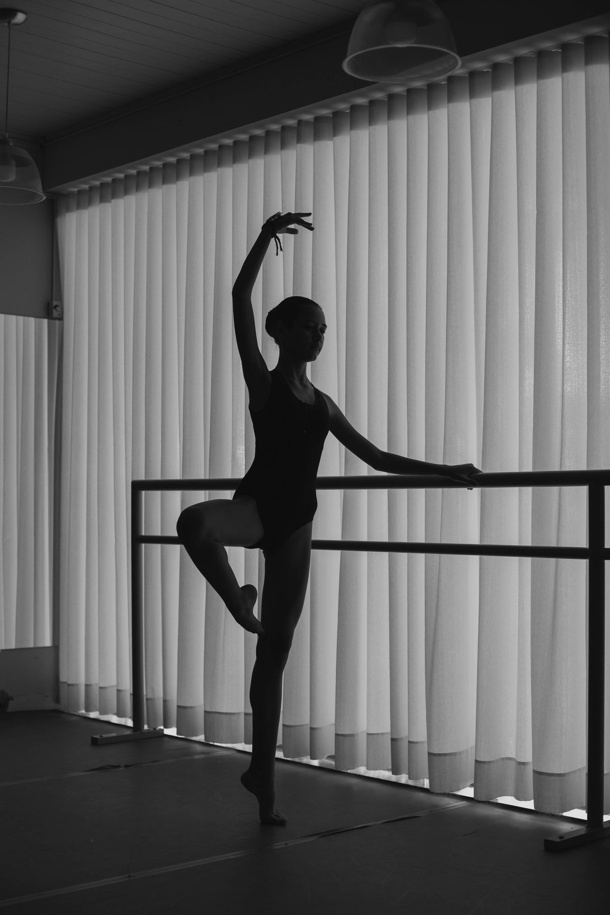 Ballet dancer at the barre in silhouette