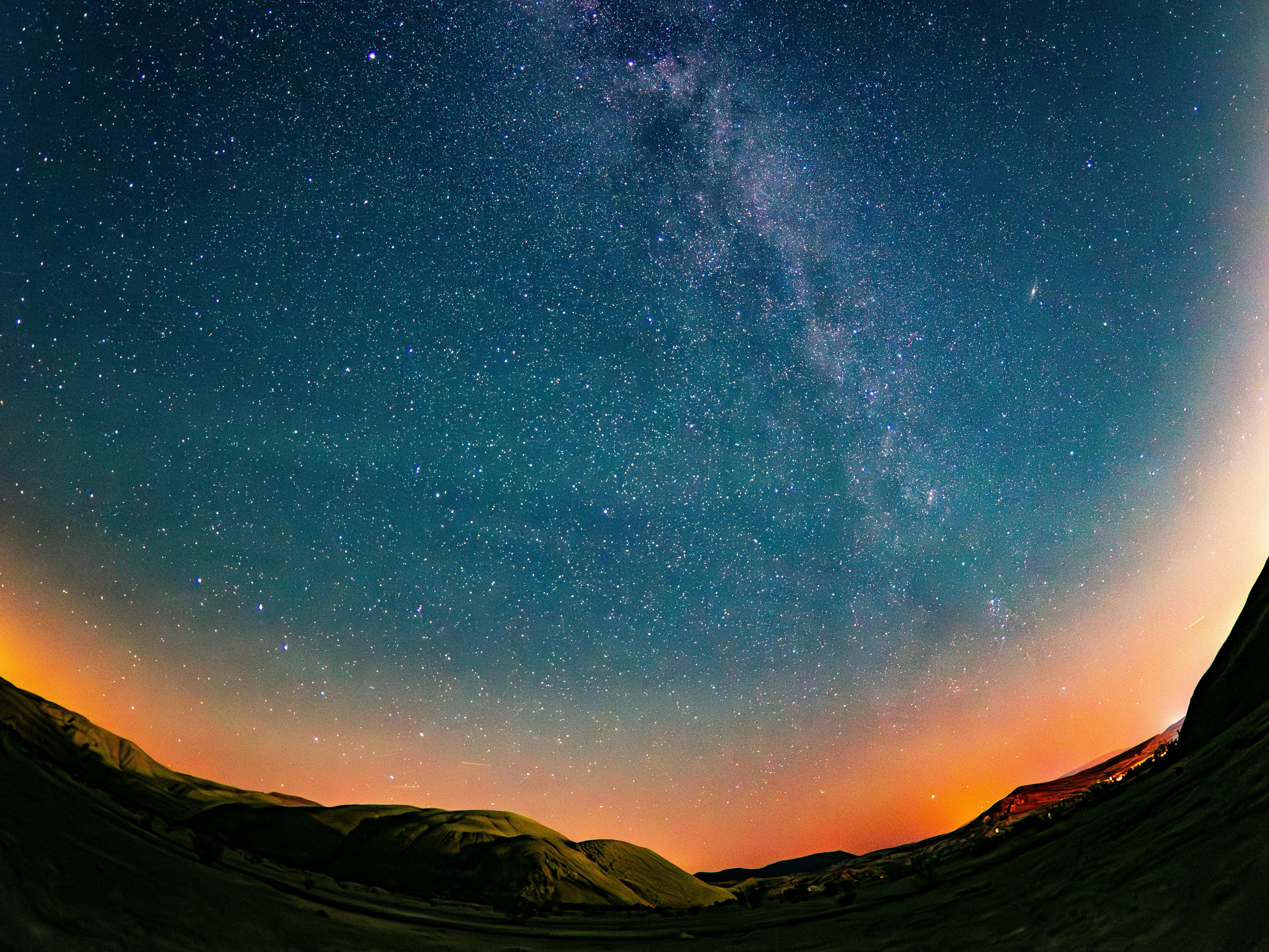 the milky way in the sky above a mountain range