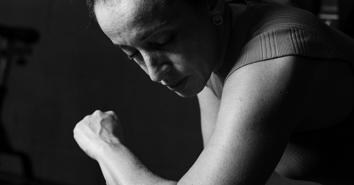 A professional massage therapist using strong pressure on an athlete's back muscles during a deep tissue massage session.