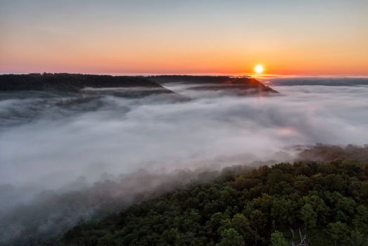 Breathtaking view of misty hills and sunrise in Weaver, Minnesota showcasing natural beauty.