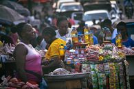 Bustling street market scene in Monrovia, Liberia, featuring diverse people and colorful stalls.
