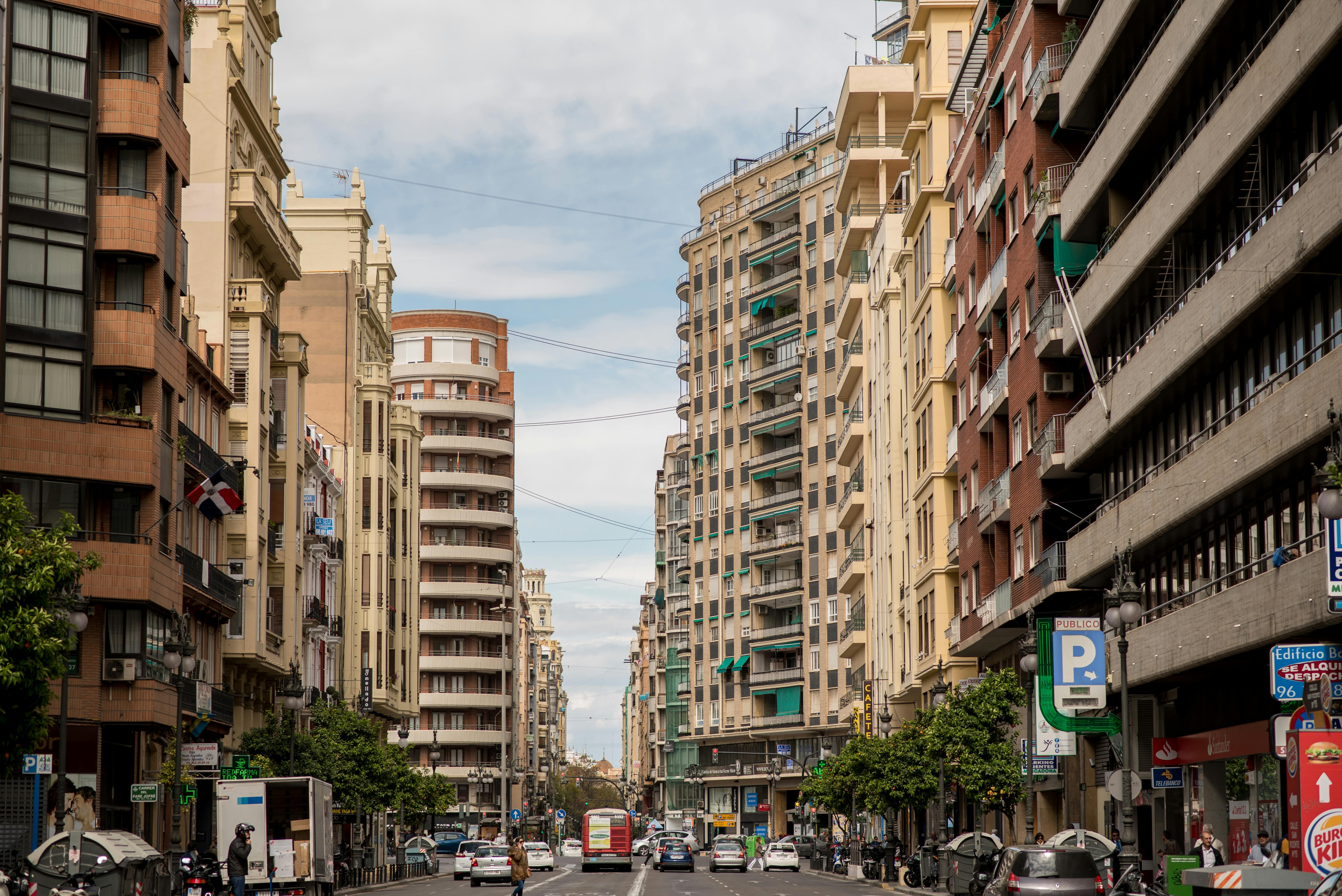 a busy River North street with clear views of public transportation and modern apartment buildings. - river north gym membership cost