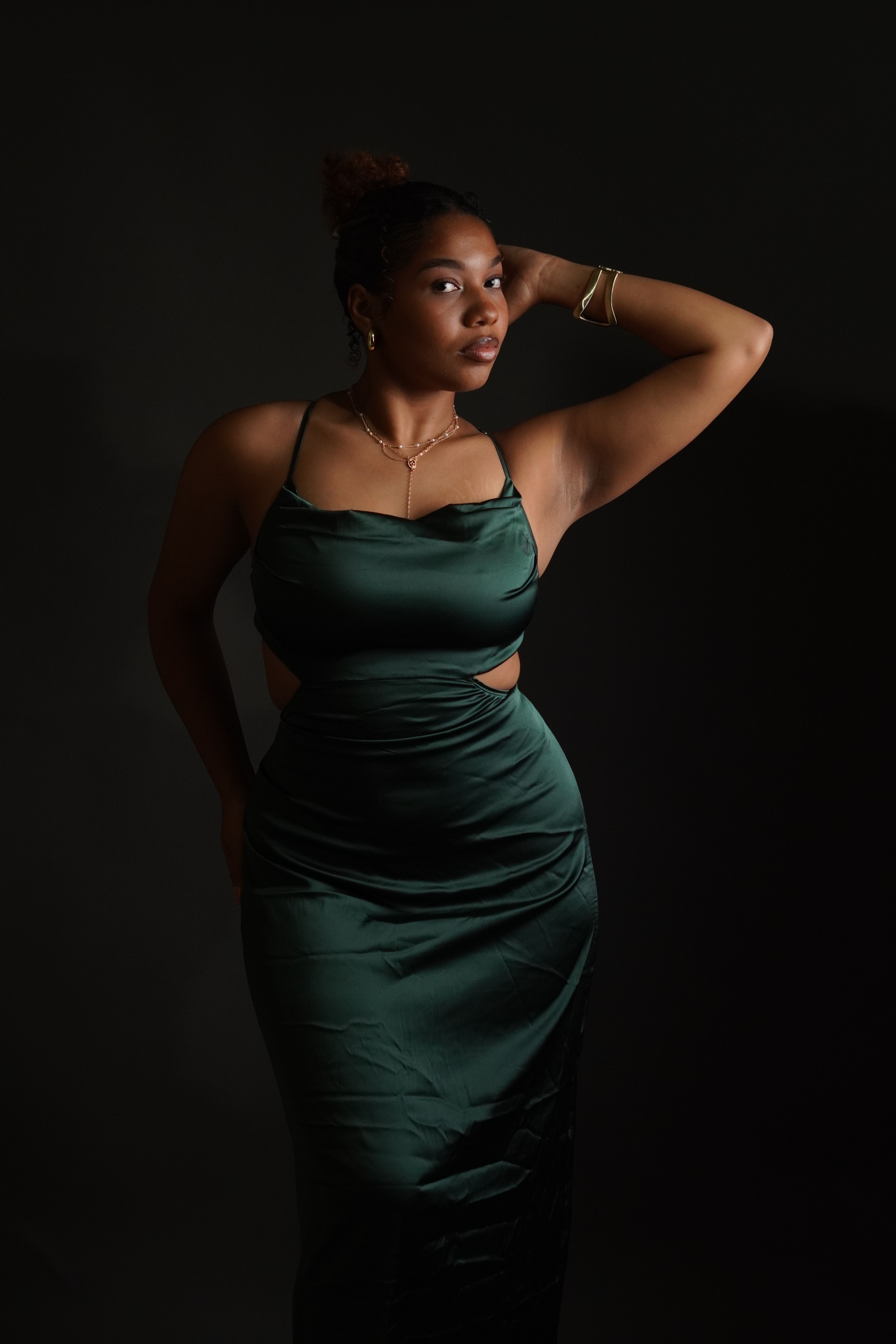 A woman in a green dress poses for a photo · Free Stock Photo