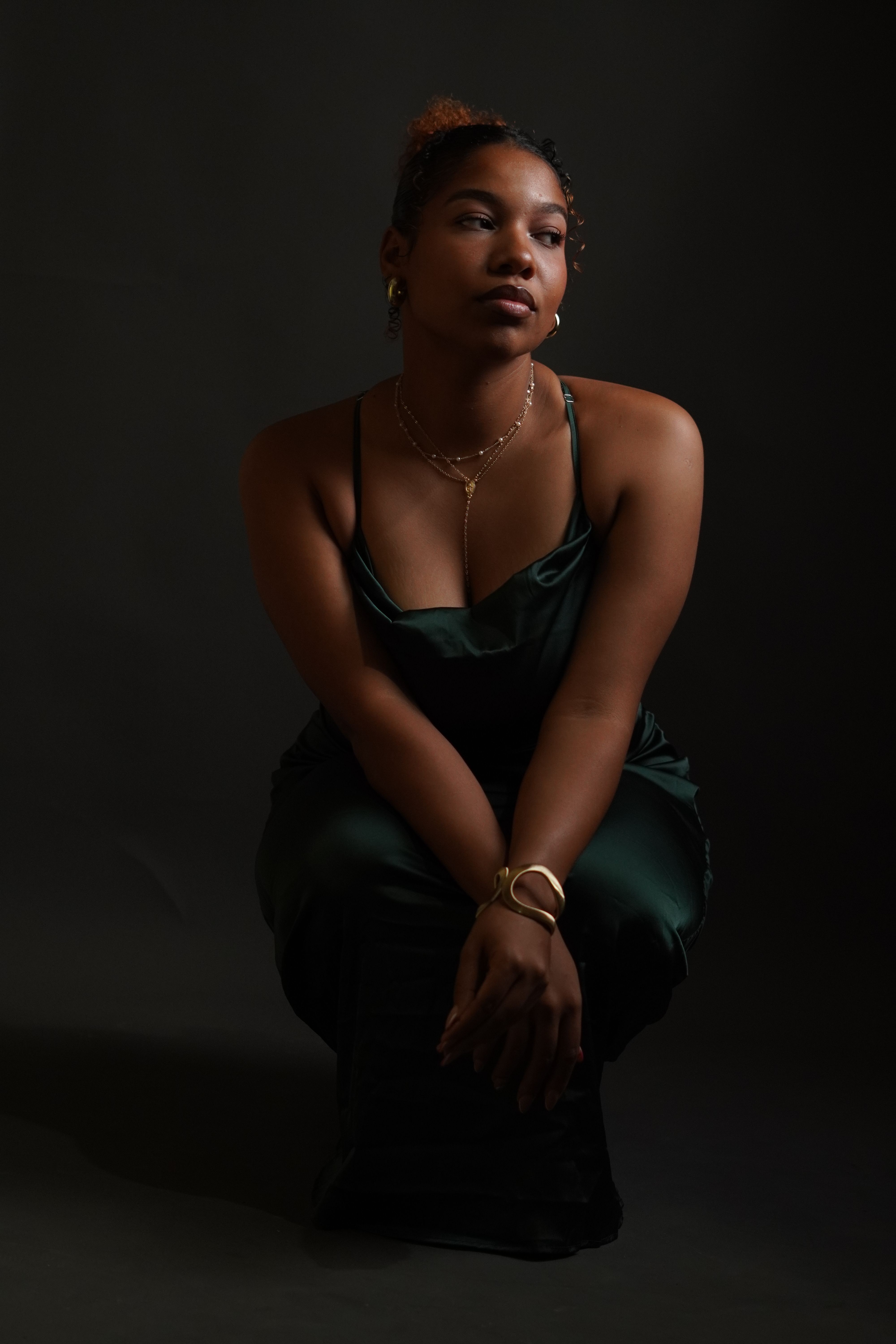 background for green dress A woman in a sitting on a black · Free Stock Photo mfgstyle_BEBE1226