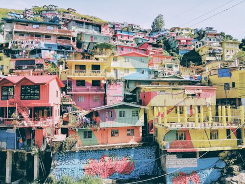 Free A vibrant display of colorful hillside houses in a dynamic townscape, ideal for urban and travel themes. Stock Photo