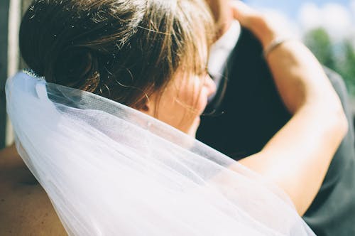 Bride Dancing With Groom in Black Suit Jacket