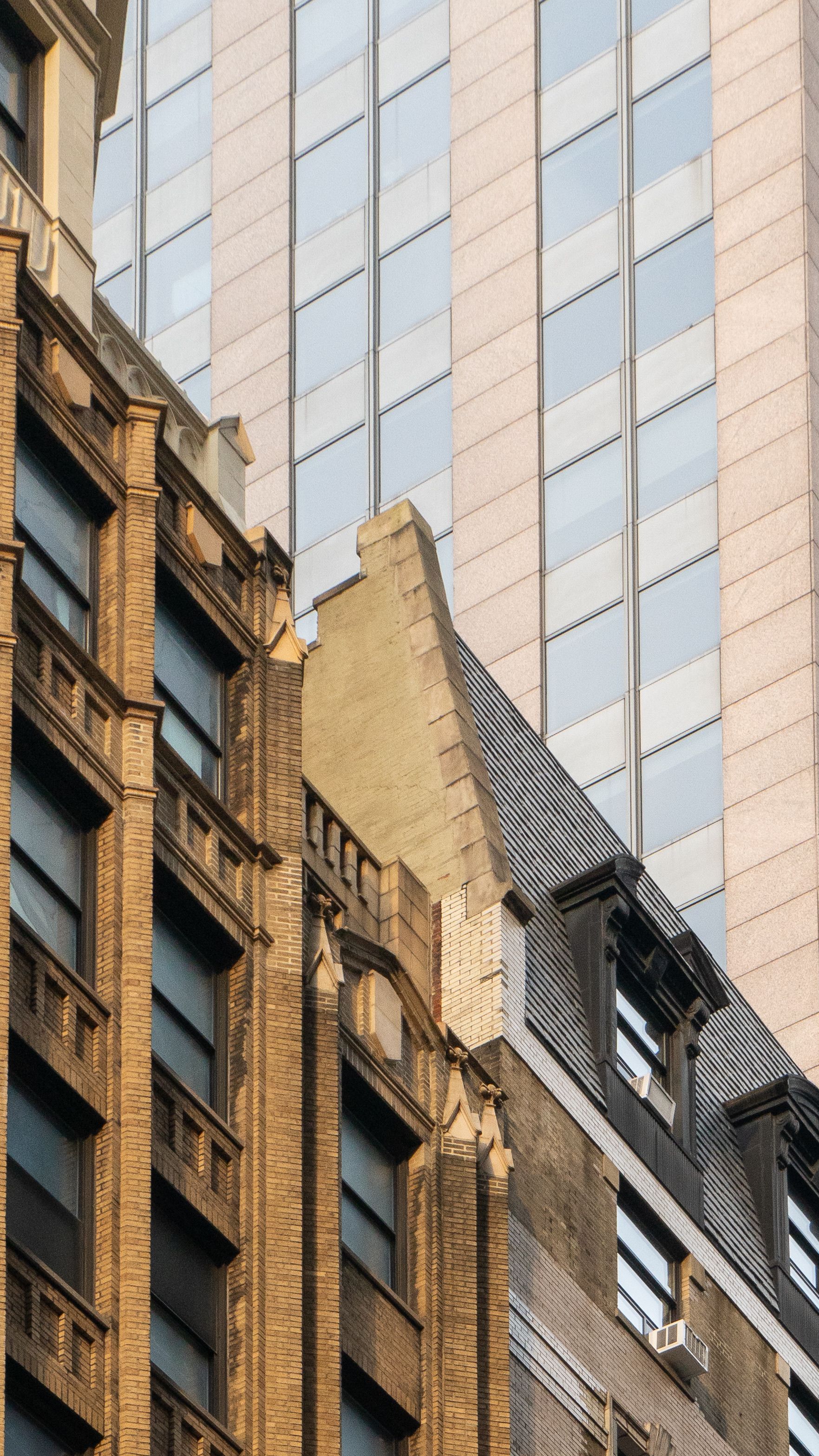 A close up of a building with windows and a tall building · Free Stock ...