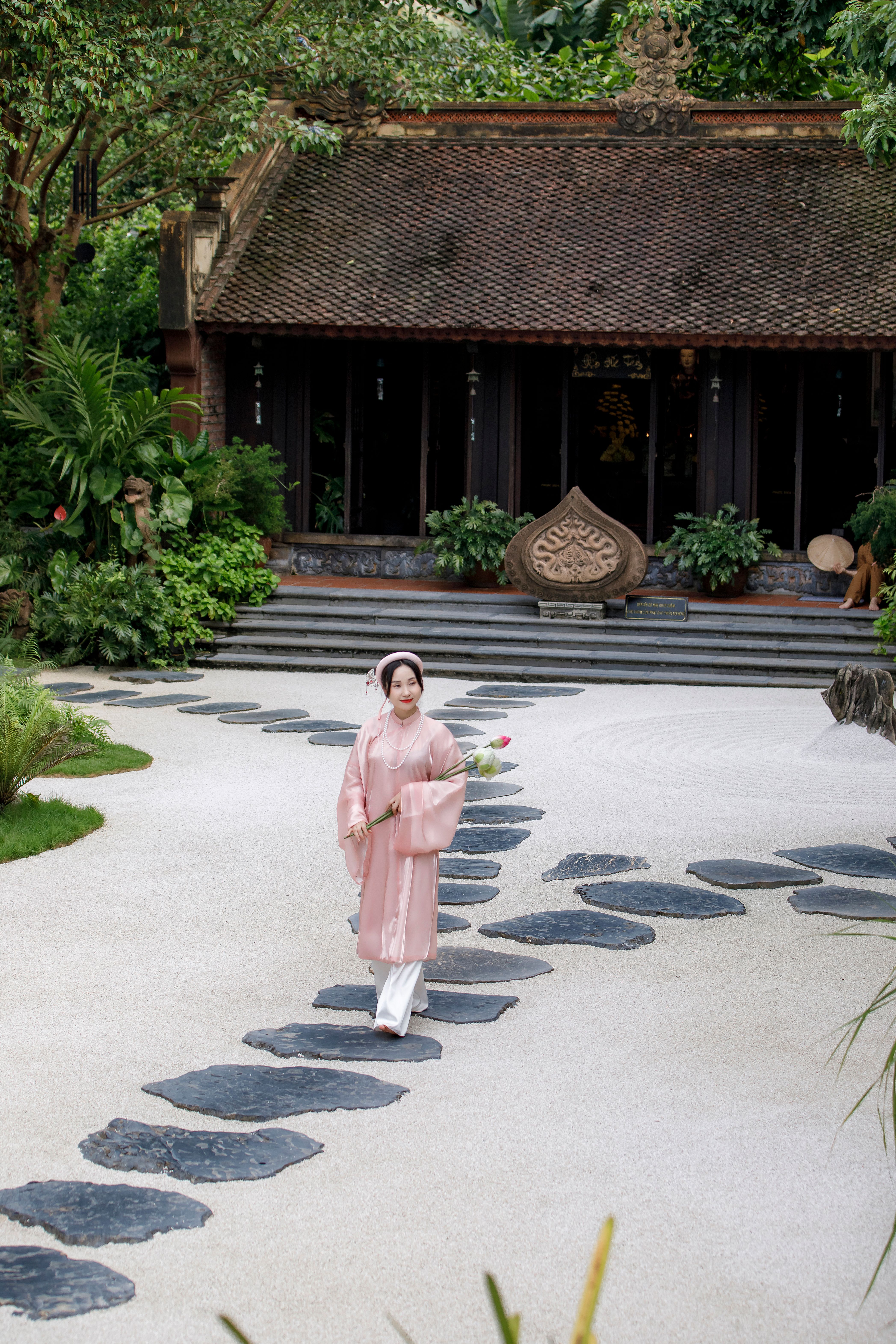 A woman in a pink robe walking down a path · Free Stock Photo