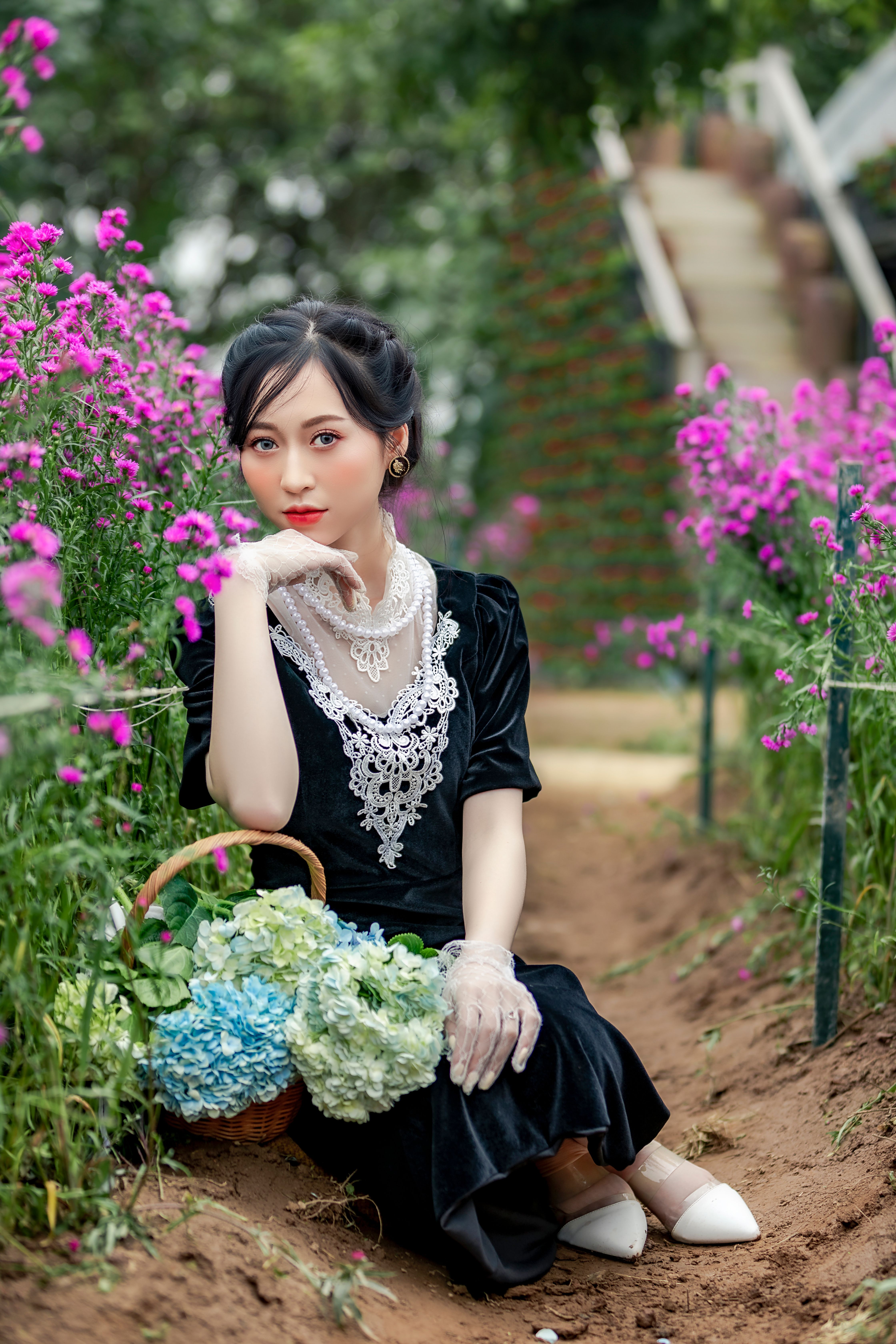Brunette in Elegant Dress Posing with Flowers · Free Stock Photo