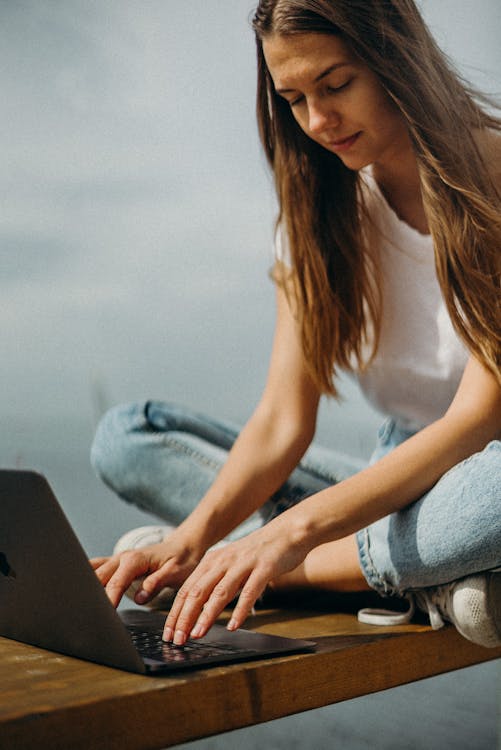 Woman Using Macbook for Software Documentation. 