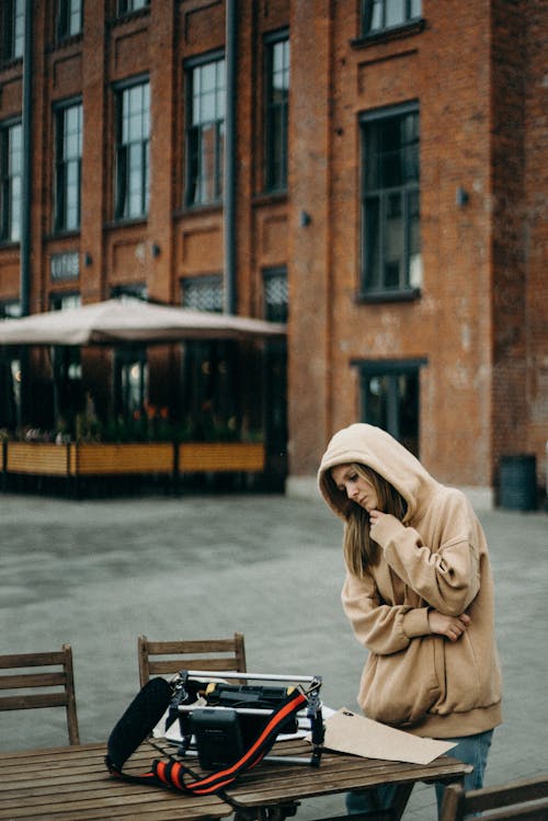 Photo Of Woman Standing Near Table