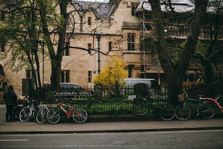 Bicycles Parked Near A Fence