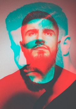Artistic double exposure portrait of a young bearded man with vibrant colors and facial expressions.
