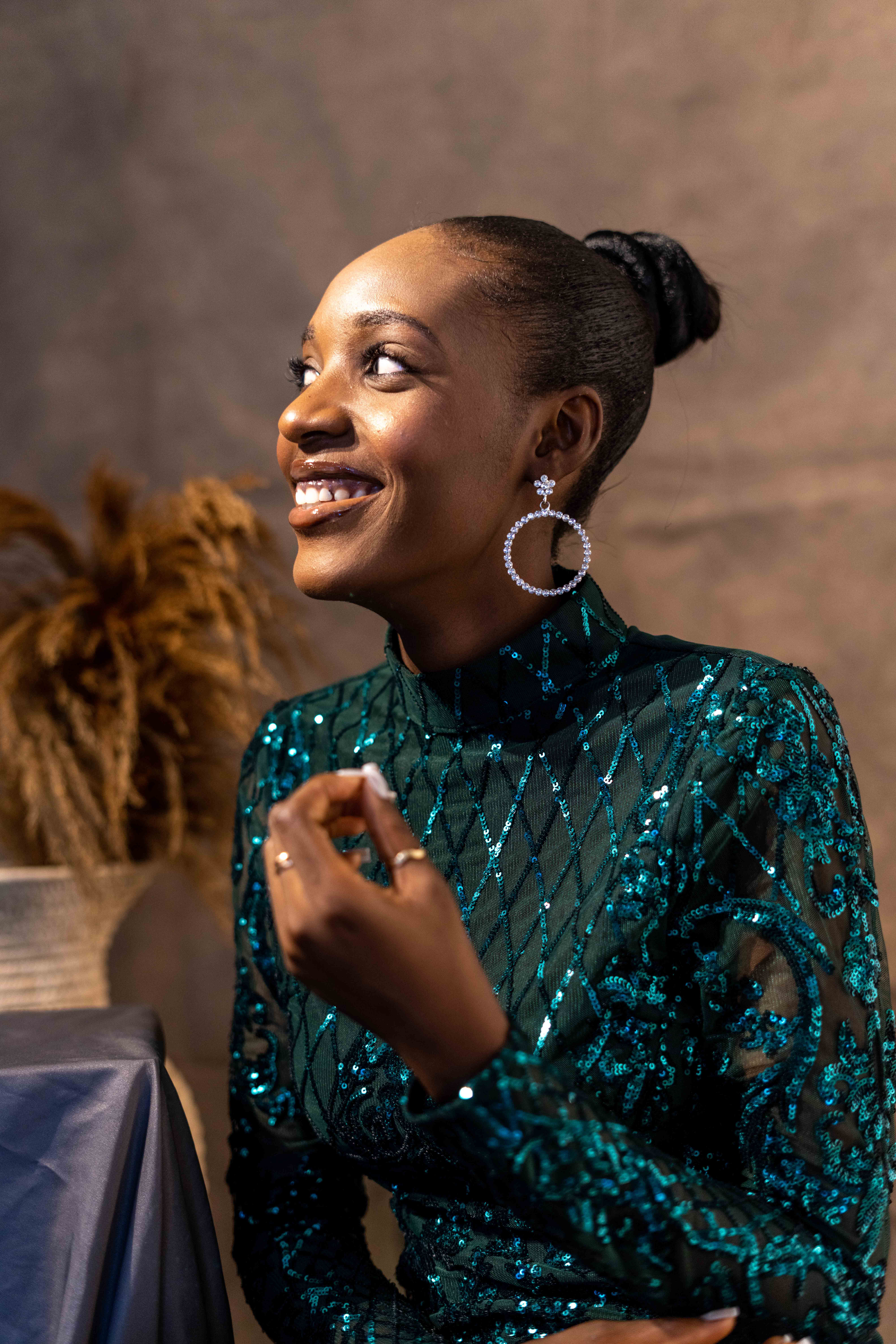 A woman in a blue sequin dress smiling · Free Stock Photo