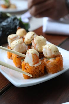 Close-up of gourmet sushi rolls topped with shrimp, perfect for culinary presentations.