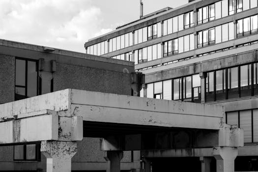 Black and white photo of urban concrete buildings with distinct architectural lines.