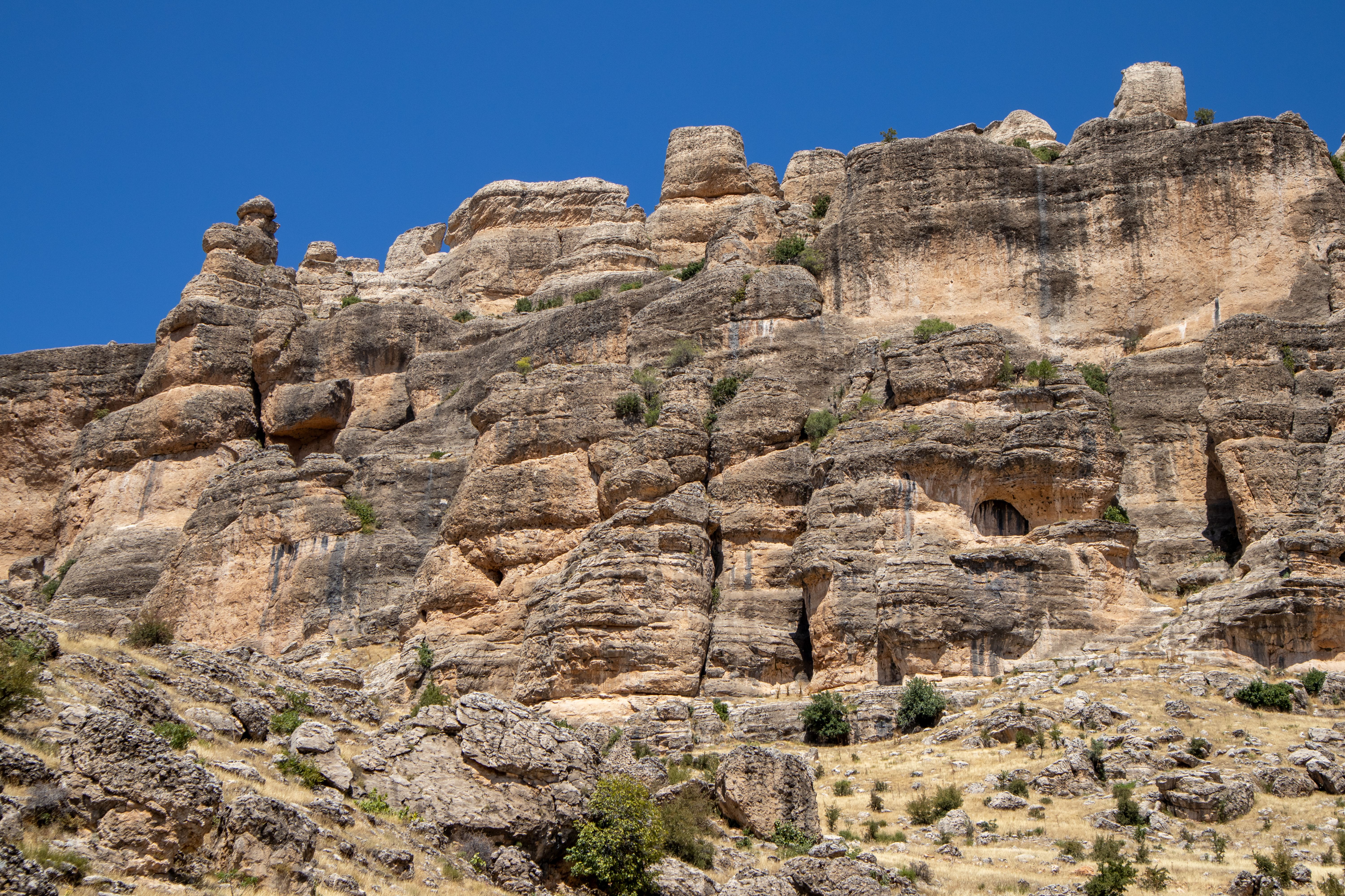A rock formation with a blue sky in the background · Free Stock Photo