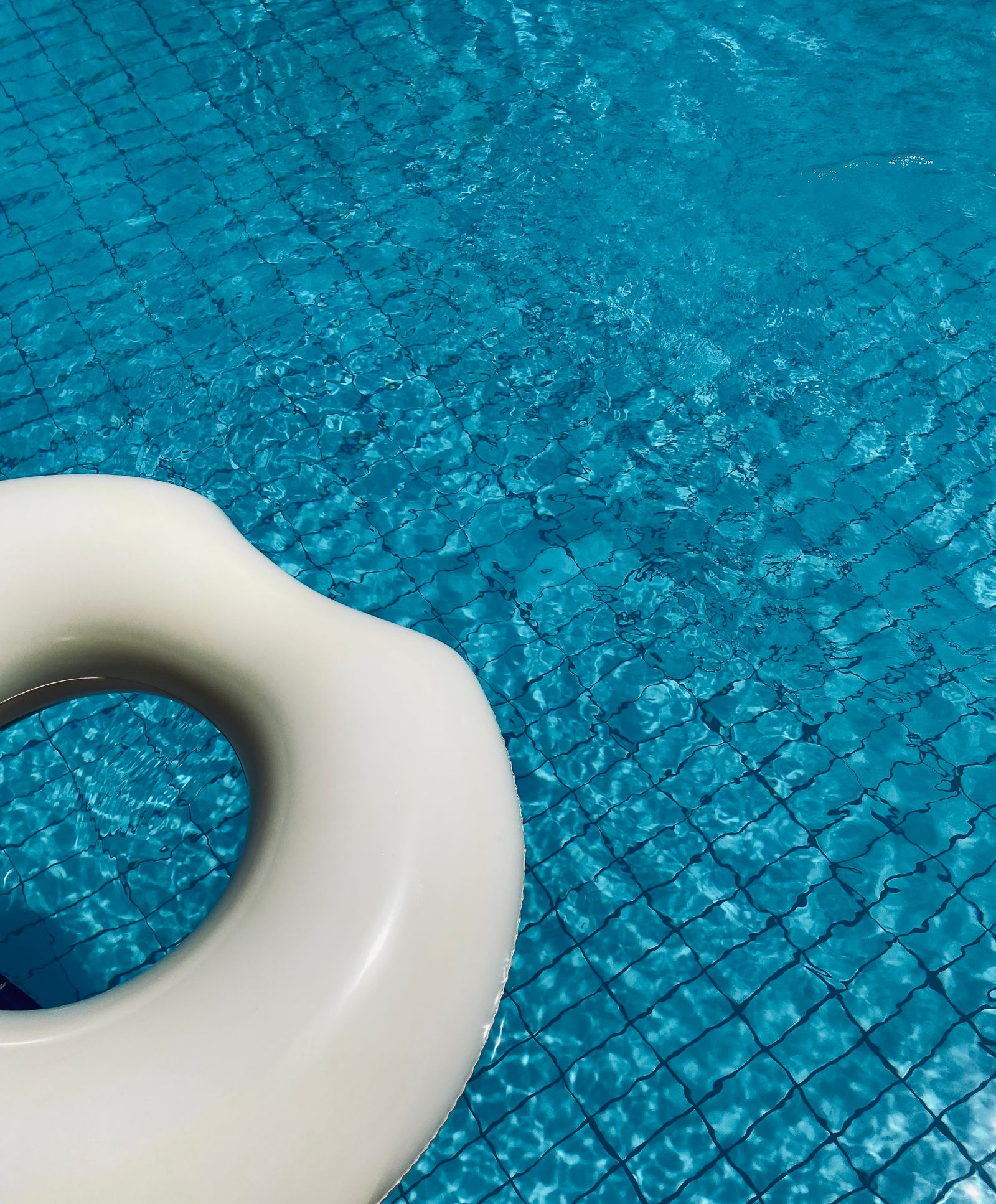 Clean blue swimming pool with a white float — Website Optimization Services for Locksmiths in Doral