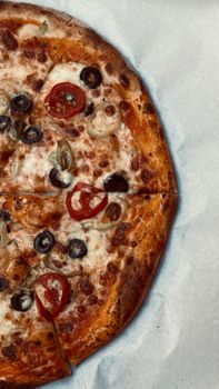 Tasty pizza topped with cheese, tomatoes, and olives, perfect for a meal.