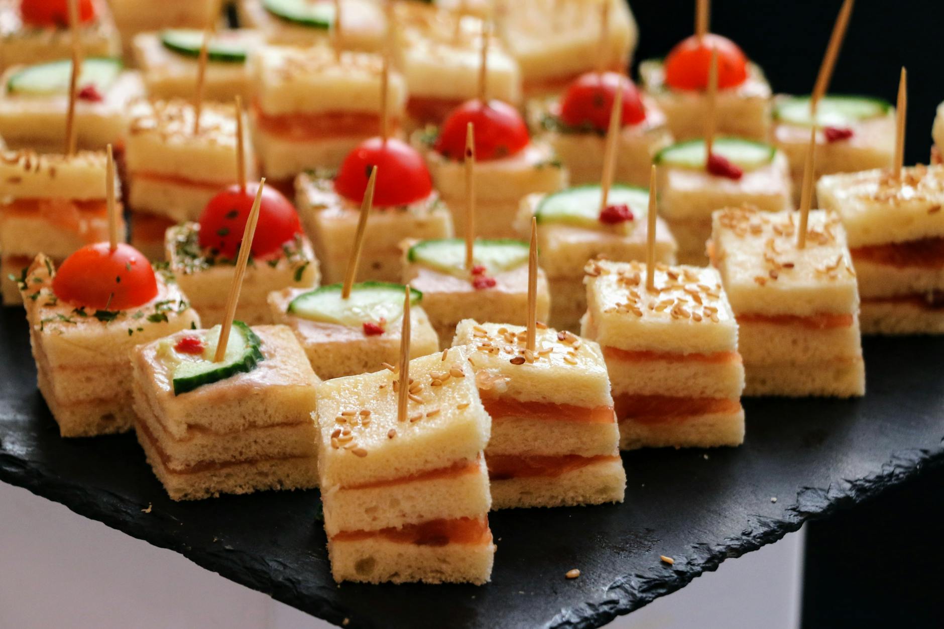 https://www.pexels.com/photo/a-tray-of-mini-sandwiches-with-pickles-and-vegetables-27741997/