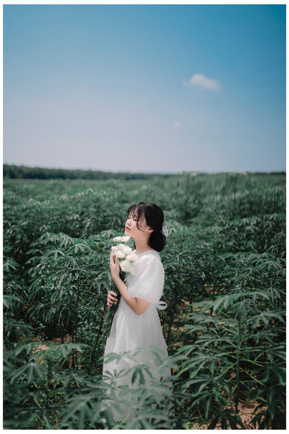 Young Model in a White Dress Posing with a Bouquet in a Field · Free ...
