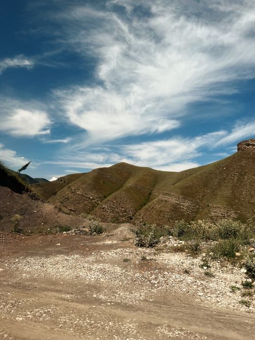 Free Serene landscape of rolling hills beneath a clear blue sky in Dagestan, Russia. Stock Photo