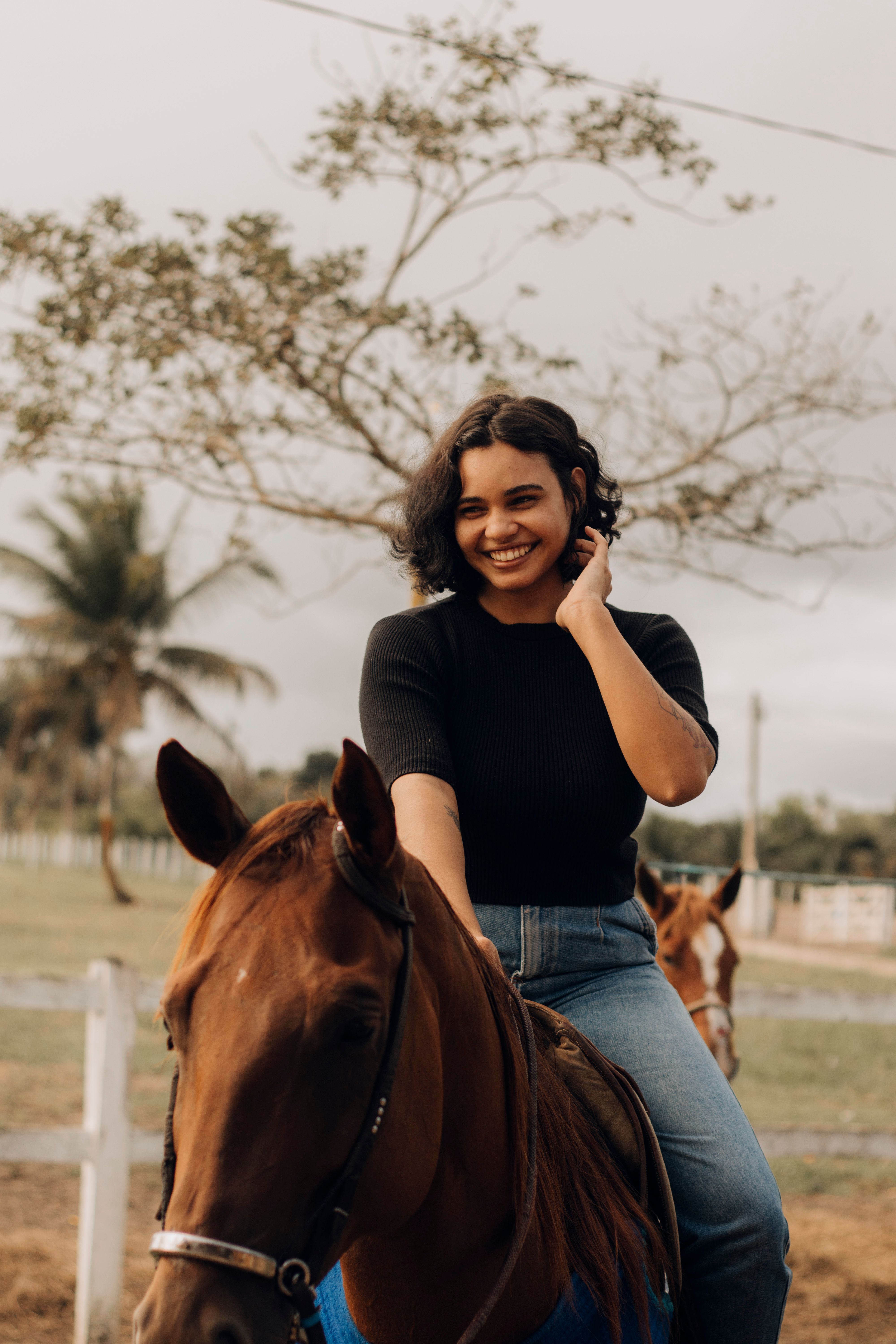 A Woman Smiles While Riding A Horse Free Stock Photo