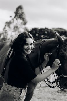 A joyful moment captured between a woman and a horse in an outdoor setting.