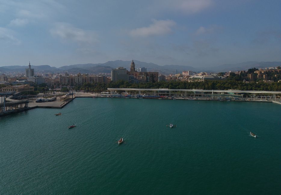 Scenic aerial view of Málaga's harbor and cityscape, showcasing boats on the bay and historic architecture. in Lamu in Visit