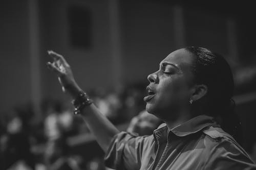 Monochrome Photo of Woman Singing