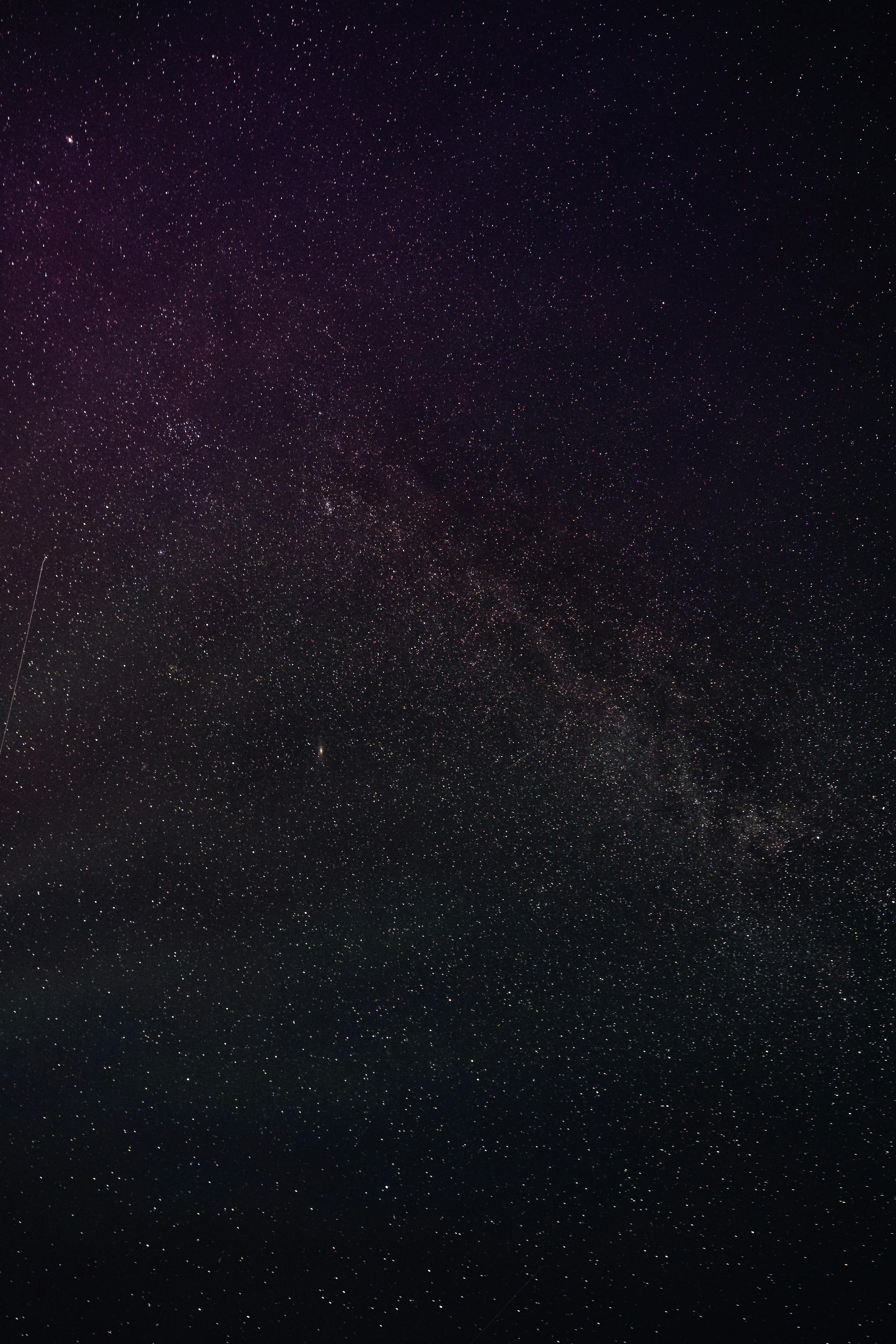 A stunning view of the Milky Way galaxy with countless stars and a shooting star in the night sky.