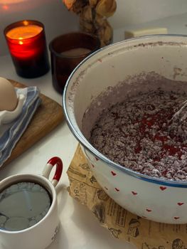 Warm kitchen scene with mixing bowl, candles, and a cup of coffee.