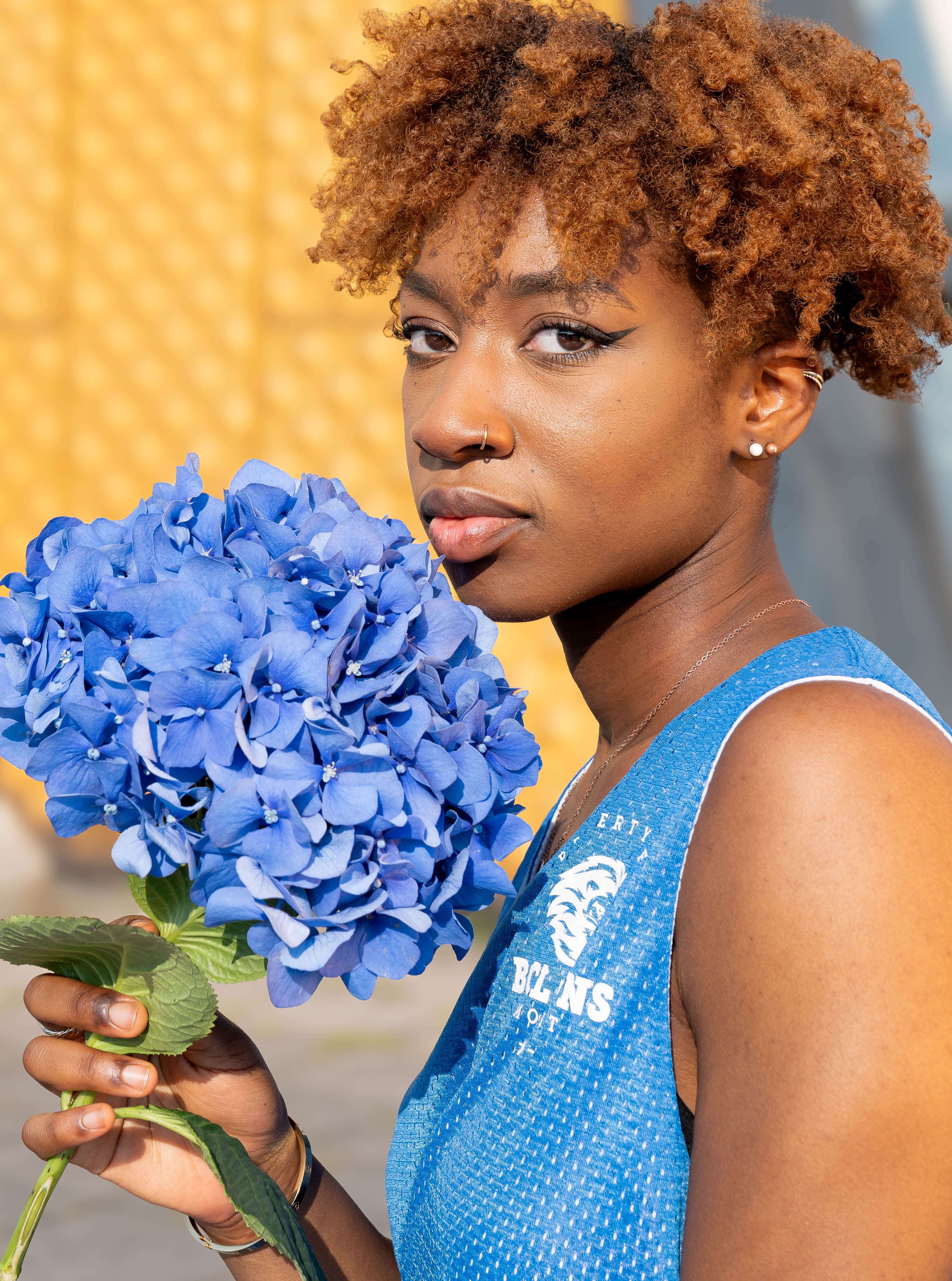 A woman with blue flowers in her hand · Free Stock Photo