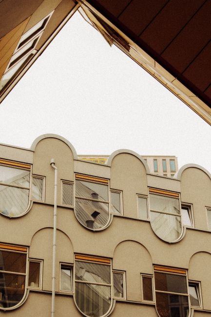 Explore a distinct modern building with a curved facade and geometric design.