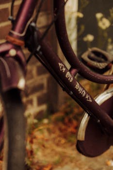 Artistic close-up of a vintage bicycle against a brick wall, featuring classic Dutch design.