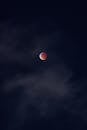 在夜空的星空中，令人惊叹的血月被乌云所捕获