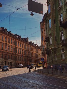 Charming Lviv street with historic buildings under a bright sky in Ukraine.