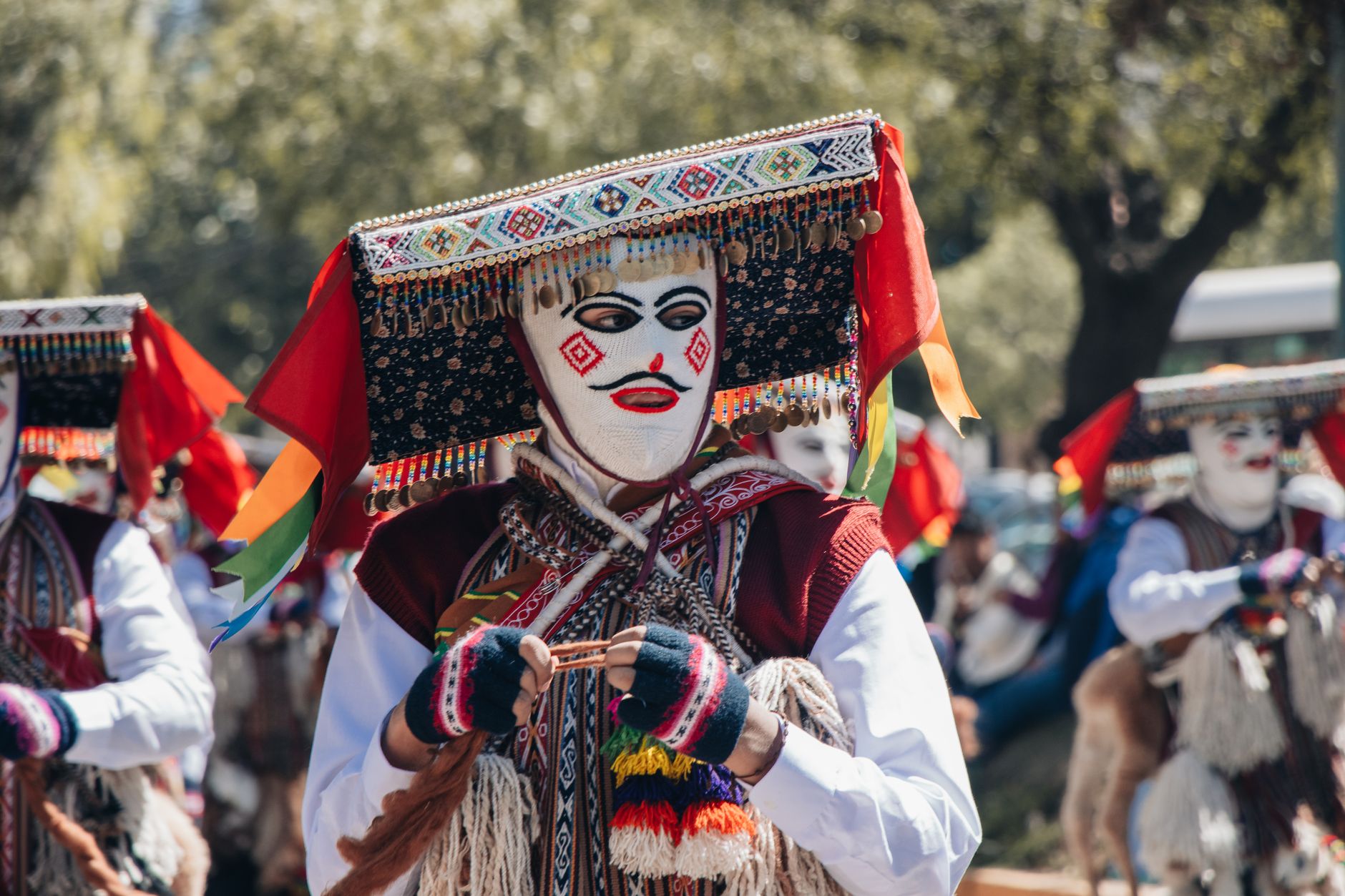 Vibrant celebration with traditional dancers and masks in Cusco, Peru.