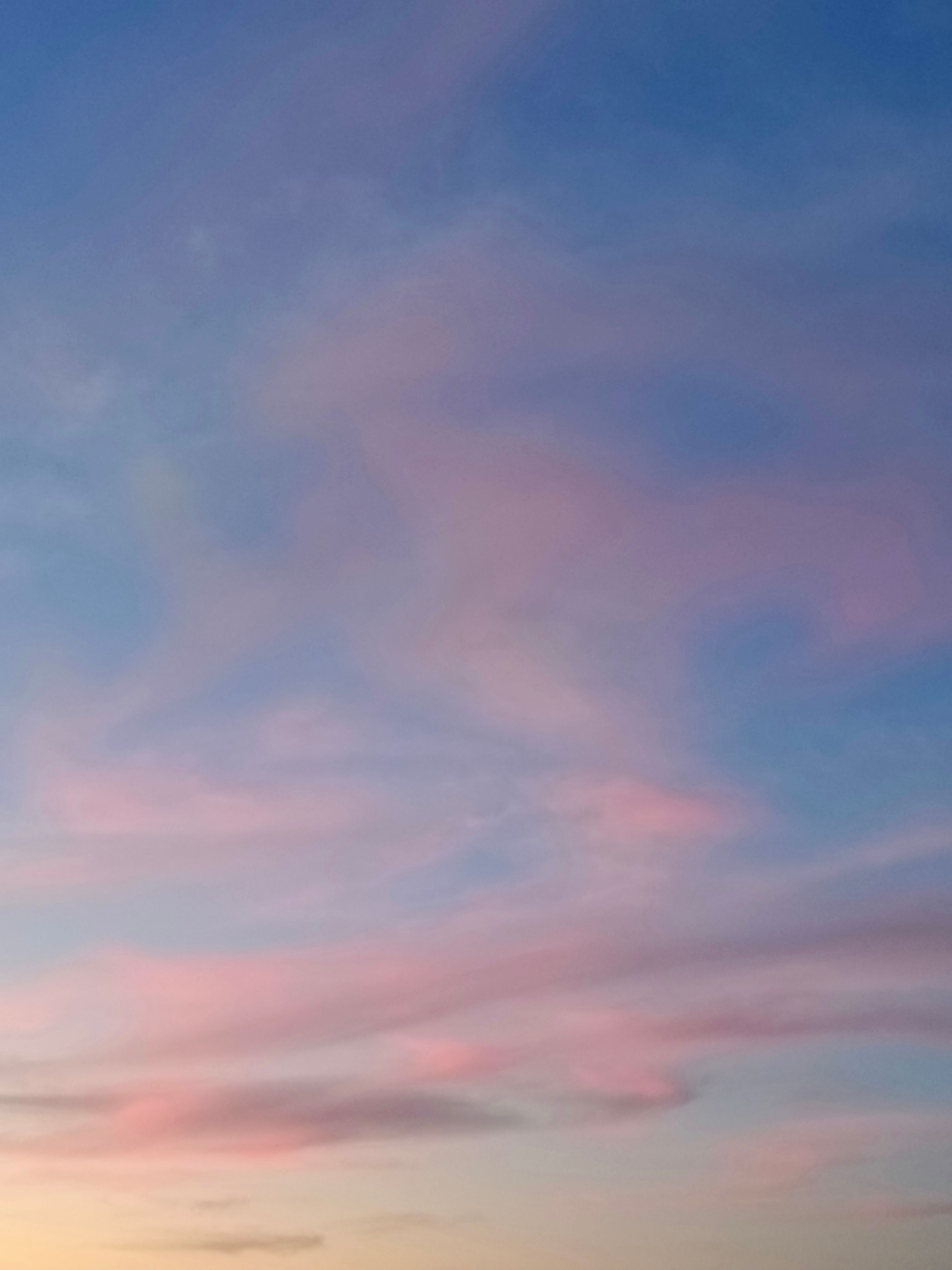 A sunset with pink clouds in the sky · Free Stock Photo