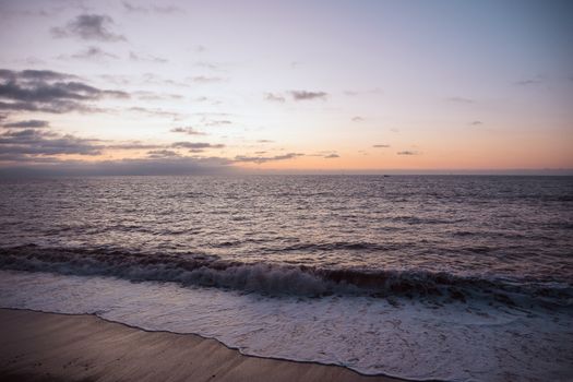 Beautiful sunset over the tranquil waters of Puerto Vallarta's beach, capturing the peaceful ocean waves.