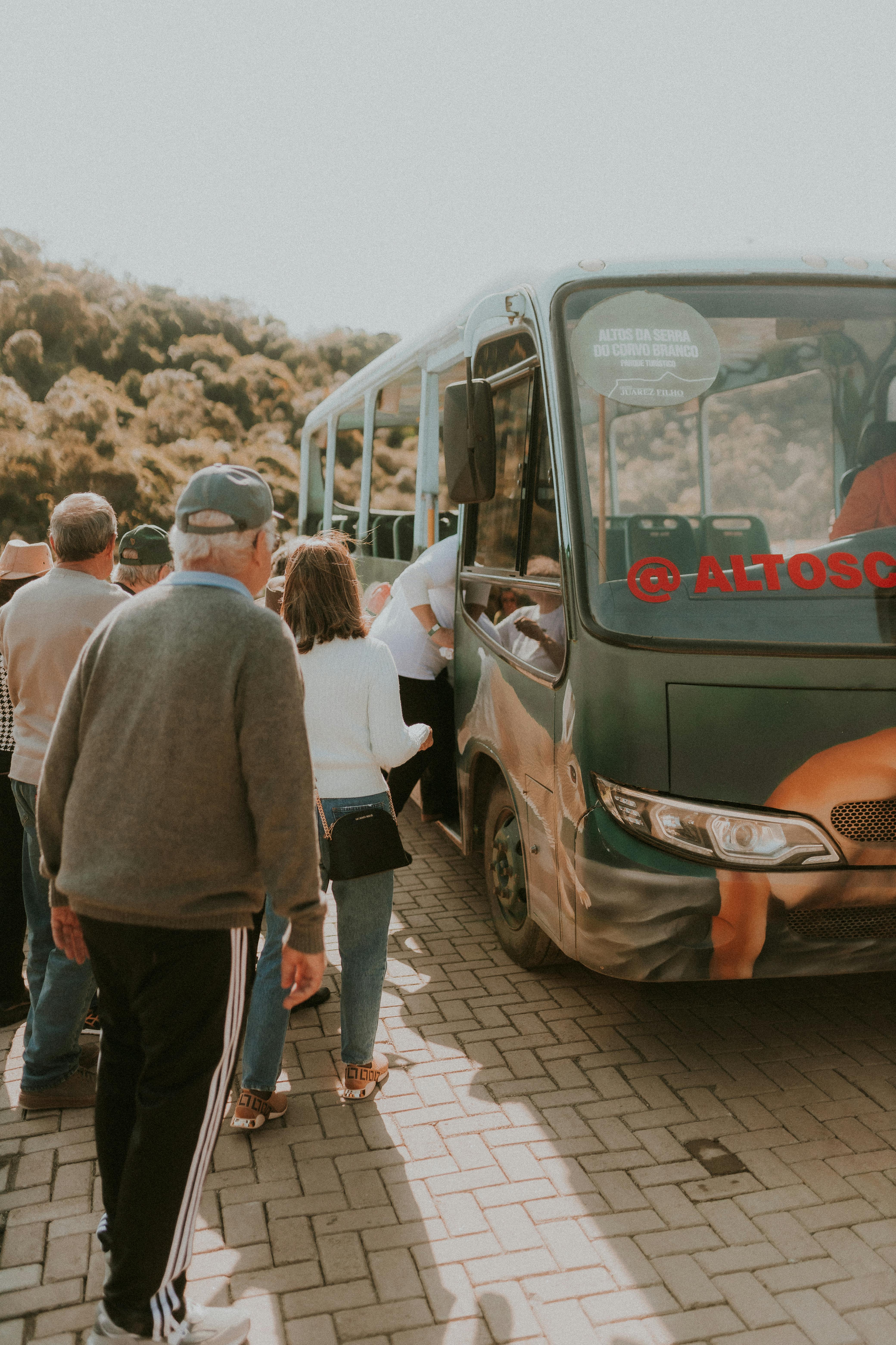 a group of people standing around a bus