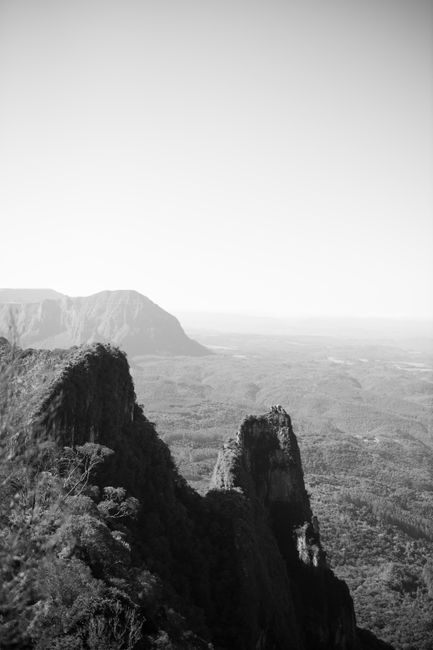 Breathtaking black and white view of rugged mountains under a clear sky, capturing the essence of wilderness.