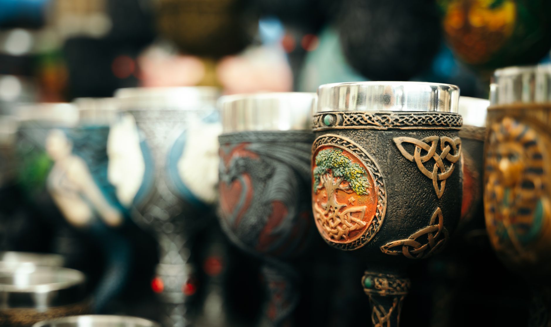 Close-up of beautifully crafted ornate goblets in a market setting.