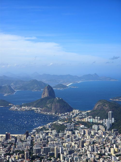 Free Stunning aerial view of Rio de Janeiro's cityscape, featuring the iconic Sugarloaf Mountain and Guanabara Bay. Stock Photo