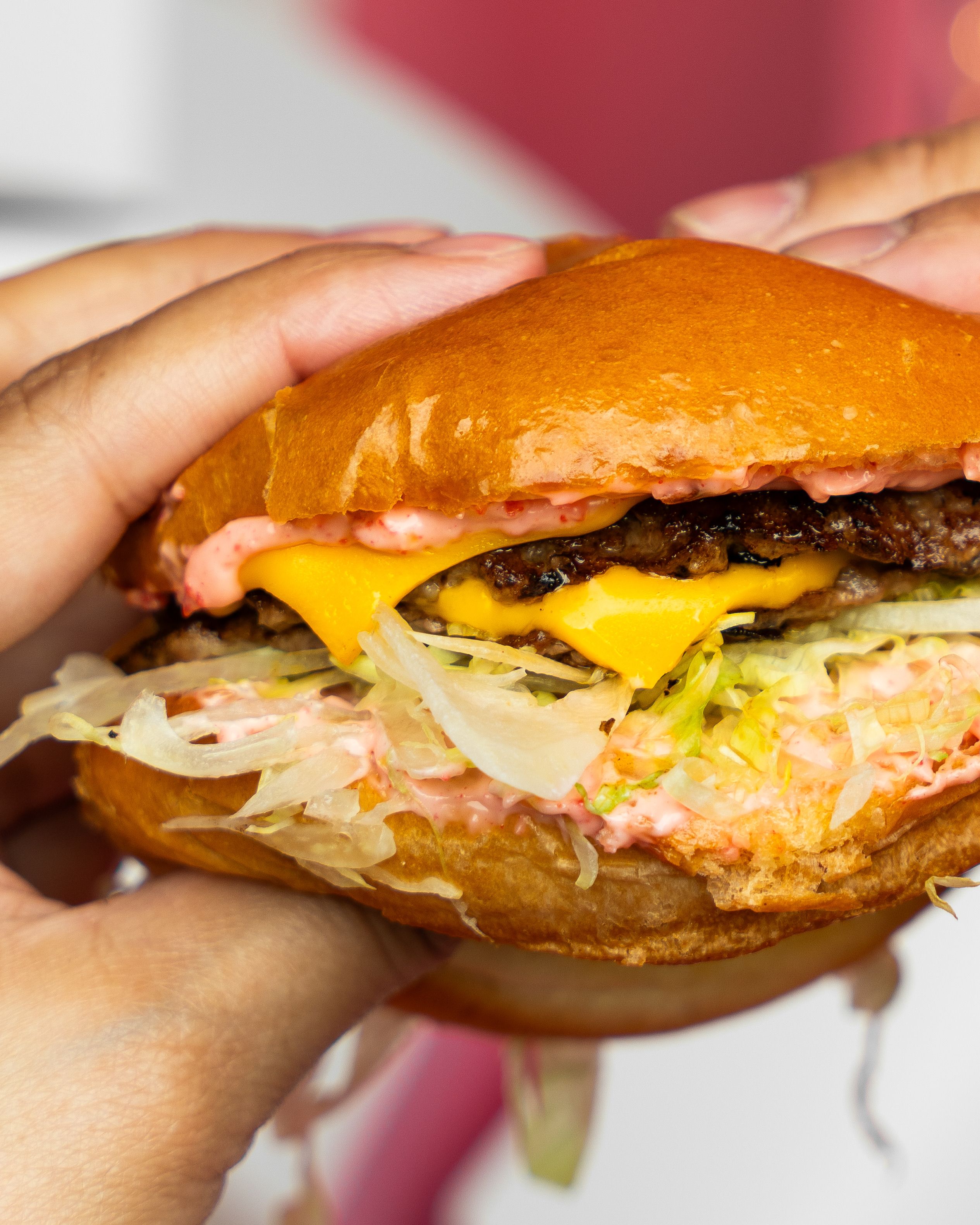 Savor a delicious cheeseburger with lettuce, cheese, and special sauce.