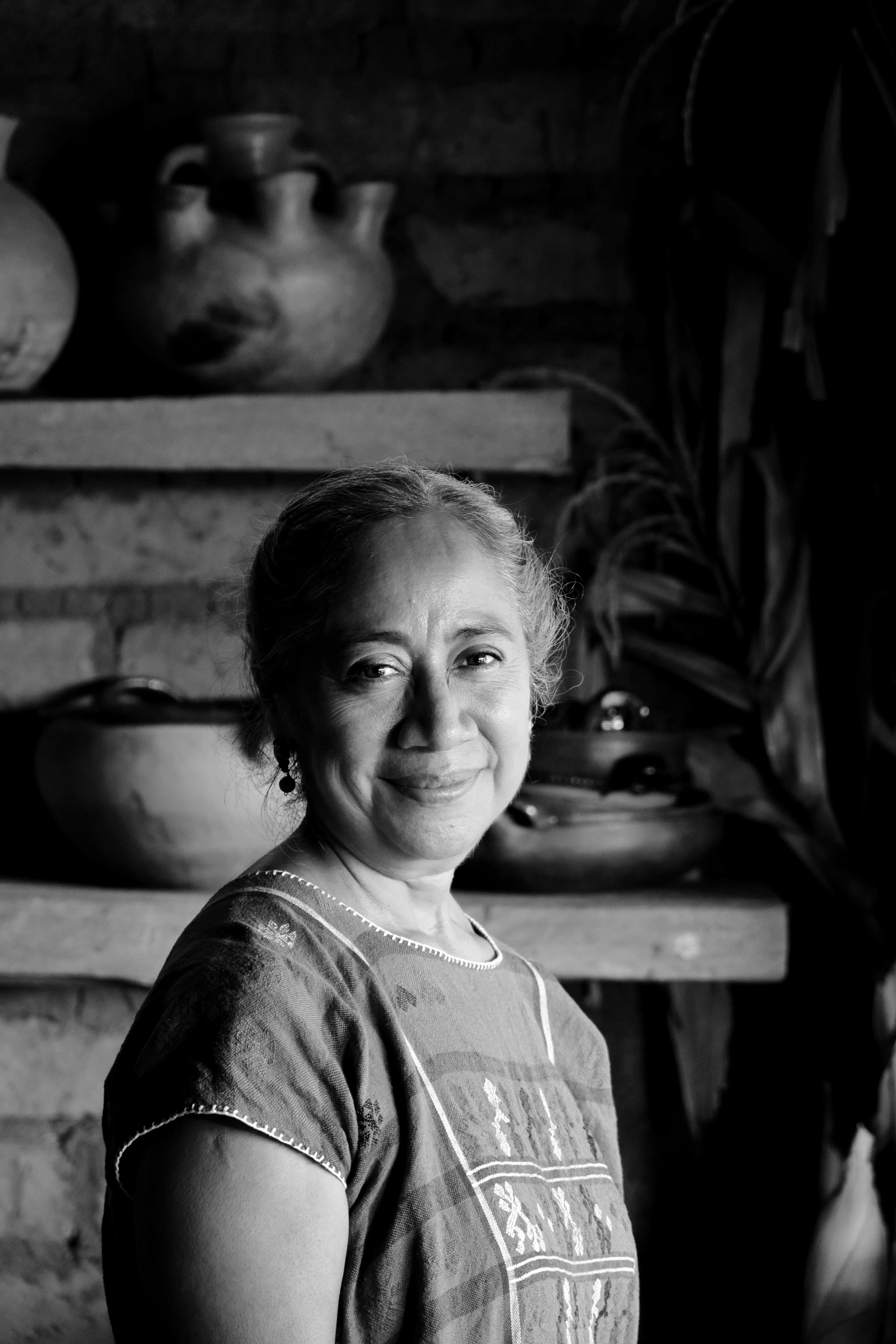 a woman in a black and white photo smiling