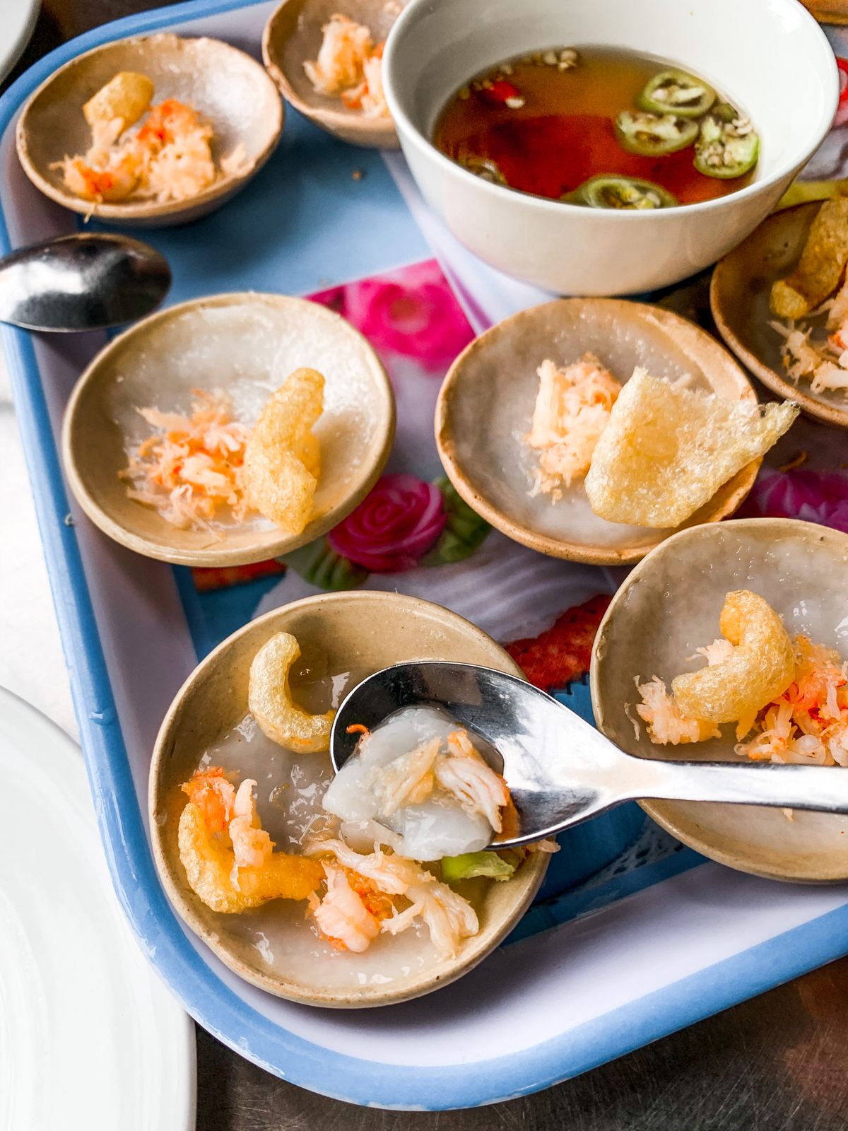 Small bowls of banh beo rice cakes with savory toppings